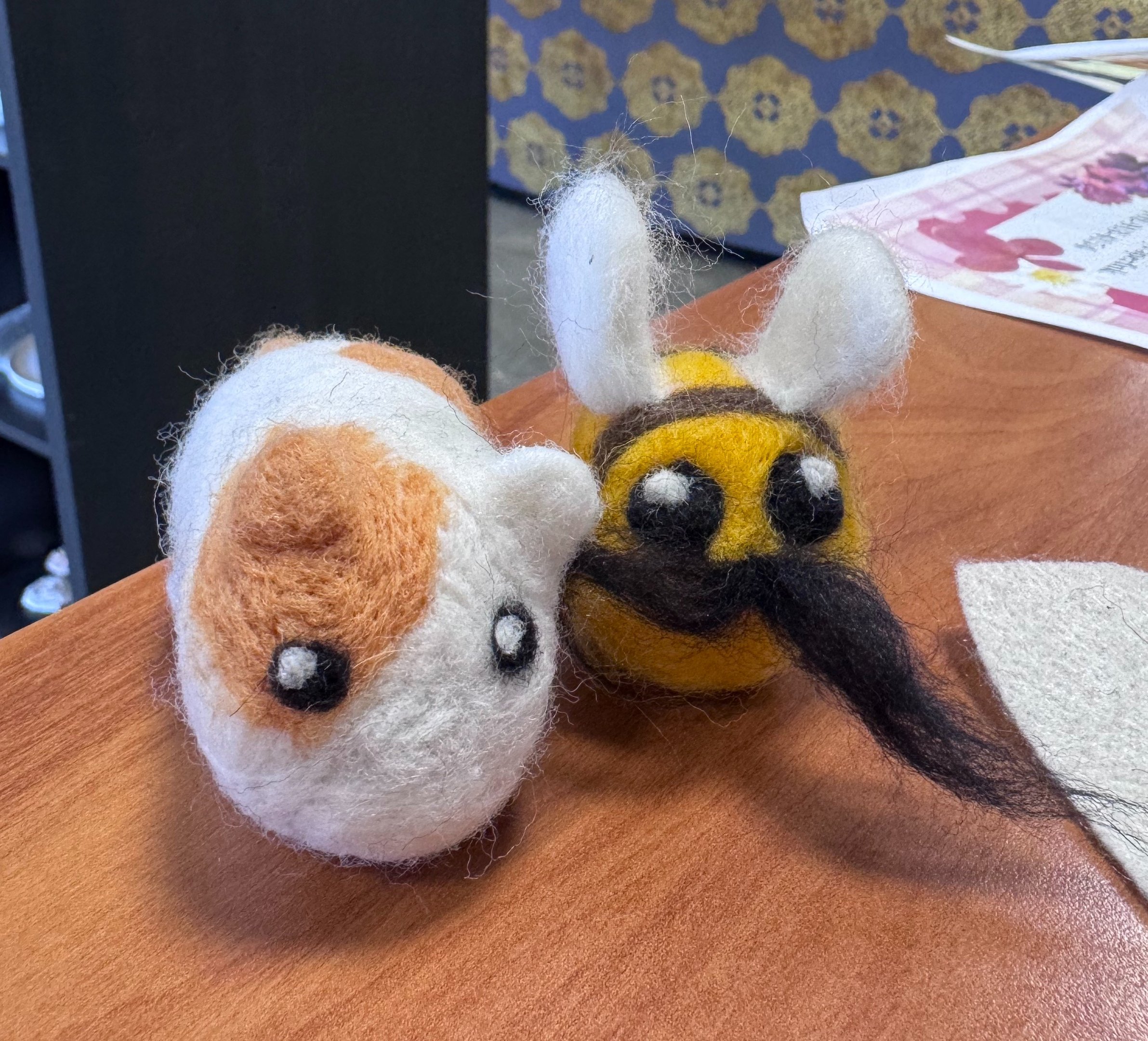Two felted animals, a bee and a small creature